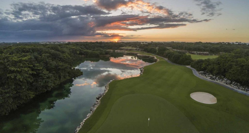 sunrise/sunset of hole 15 at PGA Riviera Maya. Features water on the left side of the hole