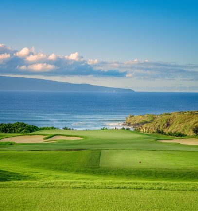 Hole 11 at Kapalua Plantation Course with ocean in background