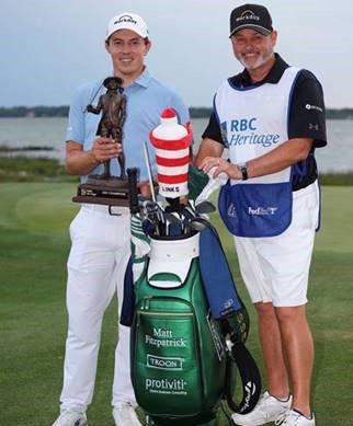 Matt and Caddy standing in back of Troon Bag