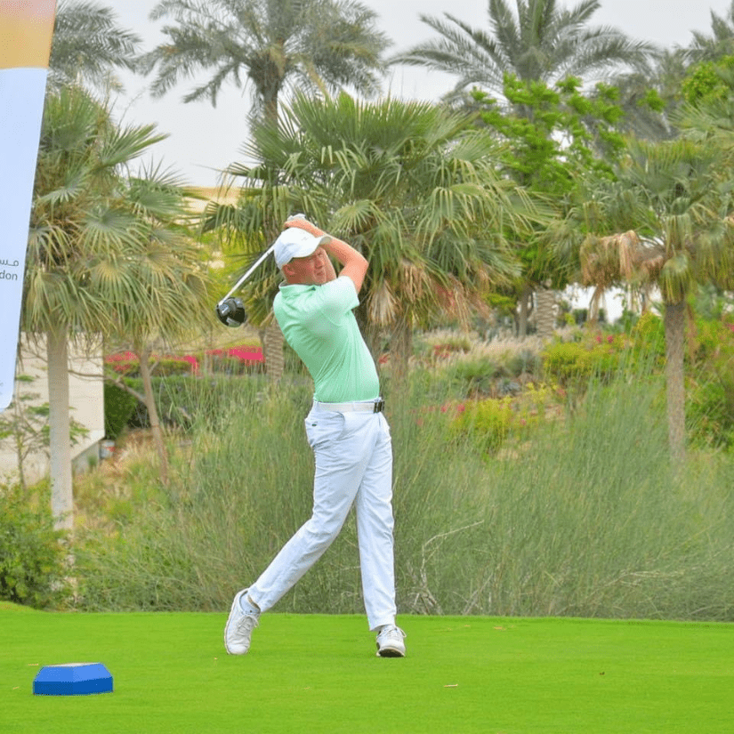 Adam dutson on the tee at Dubai Hills Golf Club